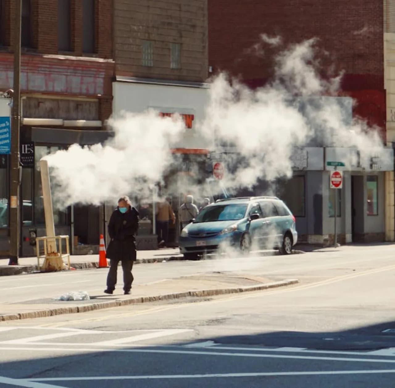 Ice removal in progress on a Canadian commercial walkway — steam, chemical, and mechanical methods compared.