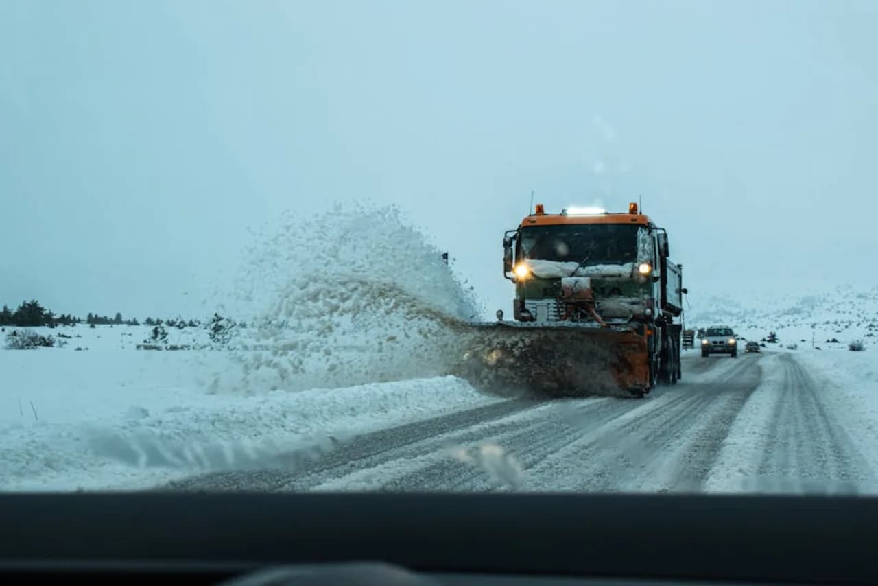 V-box salt spreader on a one-ton truck applying de-icing salt to a commercial Canadian parking lot.