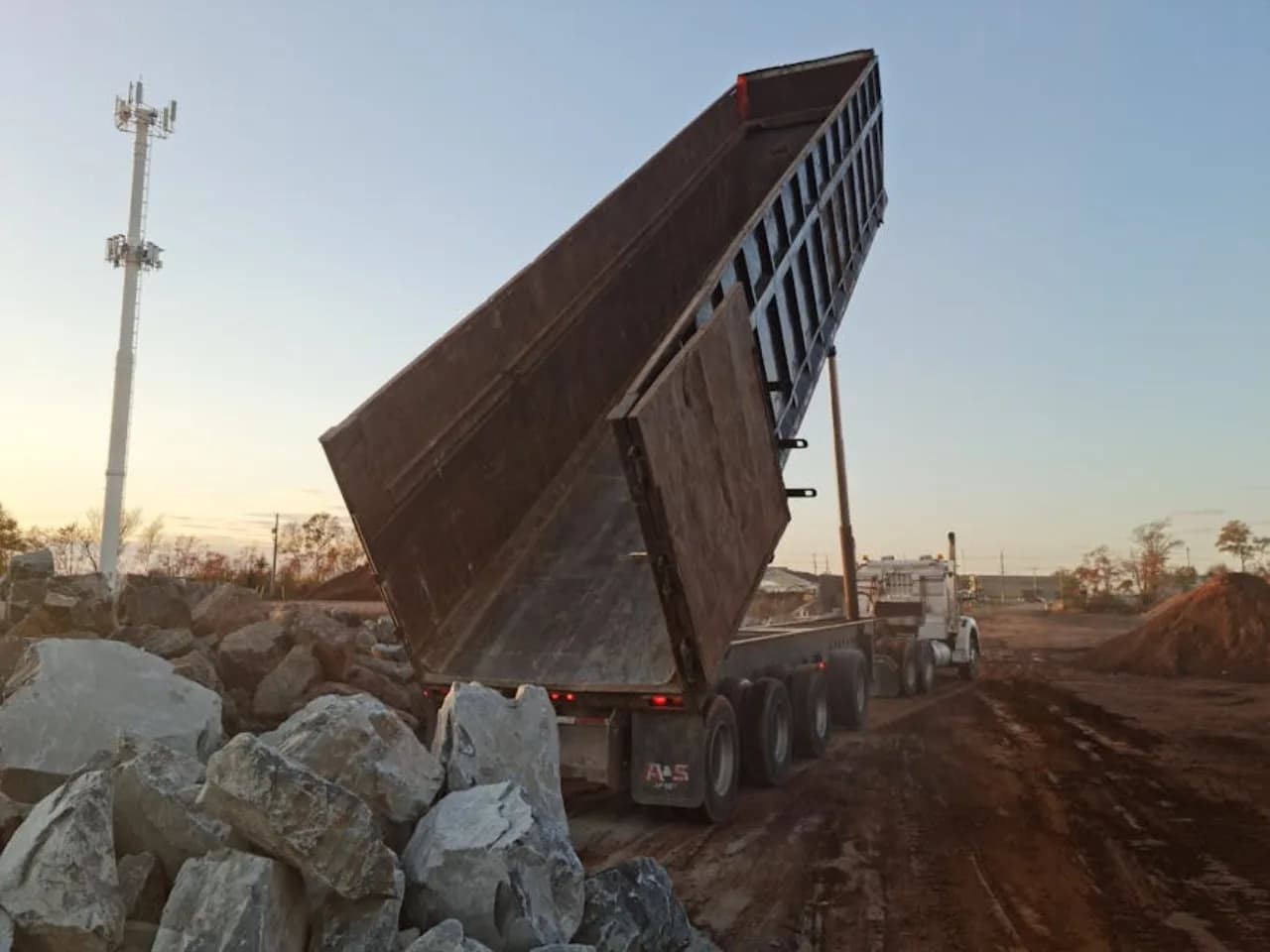 Snow hauling tandem-axle dump truck loaded for transport to a municipal snow dump in downtown Canada.